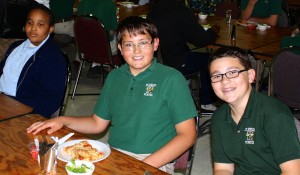 Students from St. Francis of Assisi School in Cleveland came to St. Helen School to celebrate the day together. As partner schools, they exchange letters, go on field trips together and enjoy a day doing different activities. Seventh-graders Mason Mulacek and Bradford Fram enjoy their lunch with one of their friends from St. Francis.
