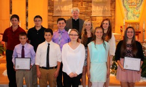 Submitted The Lake-Geauga Serra Club honored the St. Helen School eighth-graders who volunteer to serve at Masses. Receiving the award are (l to r) front row: Nathan Lewandowski, J.K. Gray, Dayna Rakoczy, Maggie Kolenic, Lily Martin; and back row: Calvin Eggert, Andrew Bolton, Trenton Lair, Fr. Jay McPhillips, Jacqueline DeRue and Clare Chesler.