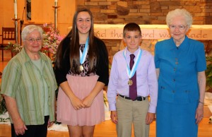 St. Helen students Lily Martin and Nathan Lewandowski are recipients of the Distinguished Graduate Award for carrying a 3.0 GPA, doing outreach to those in need and living out the Gospel in their daily lives. With Lily and Nathan are Sr. Sandy Nativio, SND and Sr. Jean Hoelke, SND.