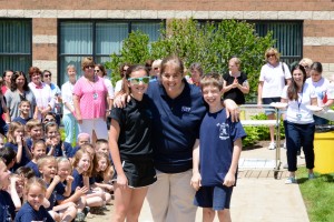 Submitted St. Mary students Erin Eppich and Nathan Bender share a hug with Kara Passow before throwing pies at her during a fundraiser to help the sixth-grade class go to camp.