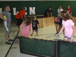 St. Helen School Summer Fitness Camp participants play GaGa, a game similar to dodge ball but played in a hexagon or octagon depending on how many people are playing. Playing are (l to r) Stephanie Hotchkiss, preschooler Grayson Russell, Chad Russell and sixth-grader Tess Ruggeri. Watching are (l to r) sixth-grader Nick Guarniere, eighth-grader Zac Wolfe, fourth-grader John Cooper, third-grader Zack Bores and fourth-grader Gavin Russell.