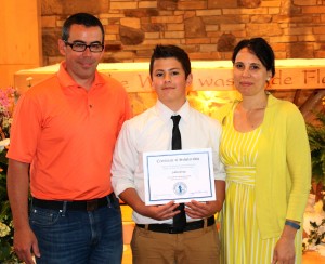 Submitted St. Helen School eighth-grader J.K. Gray is the winner of the Benedictine Merit Scholarship Award. With J.K. are his parents, Kevin and Ruthann.