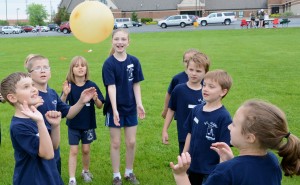 With concentration, from left, Daniel Yaniglos, Jacob Schneider, Kaitlyn Boggs, Lauren Flick, Elizabeth Passow, Brayden Riebe, Zach Baird and Rachel Suszynski work as a group to keep a balloon in the air during the annual field day at St. Mary School.