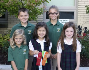 Submitted St. Helen School had many students participate in The Great Geauga County Fair. In the front row are first-graders Ava Lewandowski, who won ribbons for her vegetables; Christina Shively, who won many ribbons, including a first place ribbon for her hot peppers; and Audrey Baker, who won a ribbon for the frog-jumping contest. In back are fifth-graders Paul Ricci, who won ribbons for his dairy project; and Mercedes Sustar, who won ribbons for junior division of cake decorating.
