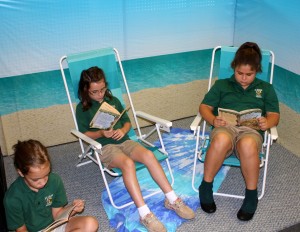 Submitted St. Helen School third-graders (l to r) Isabella Adair, Kylie Hoenigman and Allison Blasko enjoy some beach time as they catch up on some good books.
