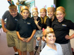 Submitted St. Mary School fifth-graders (l to r) Kyle Yates, Andrew Ryan, Annie Solomon, Eli Daugherty, Shea Finger, Claire Suszynski and Matt Organiscak sport headbands decorated with the new names they earned after reading “Sees Behind Trees” in class.