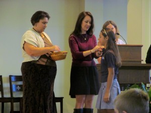 Submitted St. Mary School student Grace Morano accepts her Student Council pin from junior high teachers, Mrs. Fedak and Mrs. Joyce.