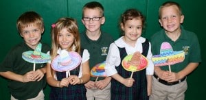 Submitted St. Helen School first-graders Roman Percic, MacKenzie Hart, Dylan Hoenigman, Amelia Clark and Danny Joyce show off their Spanish speaking skills at a recent assembly singing a Spanish song that included the days of the week and numbers.