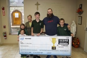 Submitted St. Helen School received a $5,000 donation from the Intel Retail Edge Program and Micro Center in Mayfield Heights. Holding the check are (l to r) kindergartner Stella Morgan; second-grader Seianna Coon; Sr. Margaret, principal; eighth-grader Gabe Williford; father John Williford; and sixth-grader Isaac Williford.