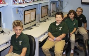 Submitted St. Helen School sixth-graders Jay Wolfe, Dawson Lair, Molly Lee and Nick Guarniere take a break from looking up information on famous Americans during computer class.