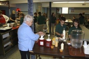 Submitted St. Helen School has a very organized system in the lunchroom. Sr. Sandy, assistant principal, gets ready to help with the condiments as fifth-graders Matthew Hart and Abby Chuckro make sure their trays are in order before starting their lunch.