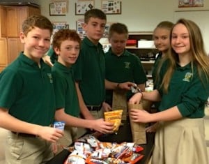 Submitted St. Helen School seventh graders Dane Berschig, Joe Barcikoski, Danny Hoenigman, Peter Brent, Jacqueline and Allie Martin prepare the breakfast bags of food items that will be distributed by St. Paschal Baylon Helping Hands Ministry to the needy and homeless of Cleveland. The goal is to pack 1,000 bags of food donated by each grade level by the end of the school year.