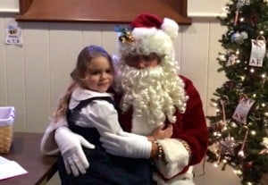 Submitted St. Helen School first-grader Jacqueline Kriz enjoys a visit from Santa during aftercare.