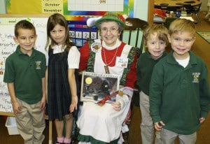 Submitted  Elf Julie (aka Sr. Julie S.N.D.) reads “The Polar Express” to St. Helen kindergartners (l to r) Aaron De Mille, Natalie Suvak, Johnny Jensen and Anthony Montagna.
