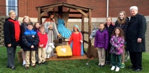 Submitted St. Helen School wishes everyone many blessings in 2015. From left are Sr. Margaret, fifth-grader Sarah Robinson, second-grader Luke Nedved, third-grader Maria Kimball, first-grader Peter Murray, fourth-grader Margaret Ruggeri, sixth-grader Allie Barcikoski, kindergartner Mykaela Cox, eighth-grader Sidney McInnerney and Fr. Jay.