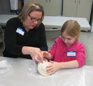 Submitted St. Helen second-grader Anna Russell and her mother Kristy Russell bake bread in preparation for her First Holy Communion.