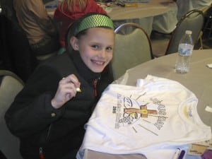 Submitted St. Helen second-grader Mary Lee spends time decorating her T-shirt during Jesus Day, a special day of prayer, activities and practice for First Communion.