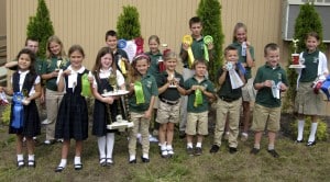 Submitted St. Helen School students present the ribbons and trophies they received from The Great Geauga County Fair. From left, front row: Christina Shively, Julia Suvak, Audrey Baker, Olivia Wojtasik, Ava Lewandowski, Kevin Suvak, Roman Percic, Kyle Nedved; and back row: Jack Slattery, Selina Sparker, Mark Ricci, Rachel O’Reilly, Gabe Wolf, Mercedes Sustar and Joslyn Borah.