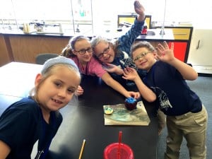 Submitted St. Mary School second-grade students (l to r) Hannah Passow, Rachel Suszynski, Kate Beuck and A.J. Cerimele take advantage of some STEM enrichment time in the science lab focusing on exploding apple volcanoes and making observations.