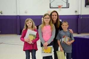 Submitted East Geauga Kiwanis Club recognizes Burton Elementary School third-graders (l to r) Isabella Clarke, Vera Smith and Collin Boyk for being outstanding students as chosen by their teach- ers. With the students is Principal Mandy Randles. Each student received a certificate and four nonfiction books.