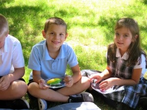 Submitted NDES second-graders Gabriel Dolan, of Chester Township, and Marisa Panko, of Chardon, enjoy music class outside on the grass at school.