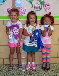 St. Helen preschool students (l to r) Mary Kate Charmley, Marena Whitely and Molly Percic proudly display the ribbons and trophies they earned at the Great Geauga County Fair.