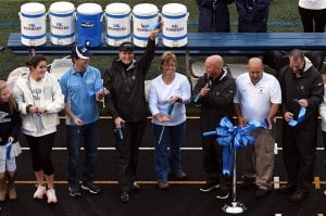 Submitted Kenston recently held a ribbon cutting to commemorate the official opening of its renovated athletic stadium. From left are Summer Corcoran; Grace Cannon; Chris Ickes; Superintendent Nancy Santilli; Dr. Beth Krause, board president; Jeremy McDevitt; Tom Byich; and Scott Pierce.