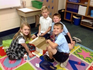 Submitted Second-graders recently learned all about different types of communities and then worked together to create models out of shoeboxes using household and classroom items. From left are Gia Ricca, Paul Williams, Vincent Sbrocco and Carmen Cirino.