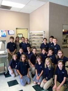Submitted St. Mary School fifth-graders sit in front of the apple pies they baked for the church’s community supper.