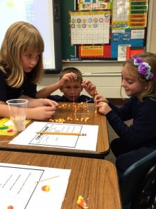 Submitted First-graders Amelia Lawrence, Jason Sotkovsky and Aubrey Yeager build towers out of candy corn.