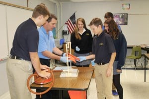 Submitted Working with health and physical education teacher Rob McBrayer, freshman Justin Satterlee, of West Farmington, inflates a pair of healthy pig lungs with classmates Clare Boland, of Chardon, and Kyle Borah, Middlefield, to examine as part of their study of respiratory health.