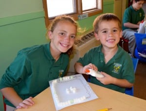 Submitted St. Helen sixth-grader Tara Barcikosi and kindergartner Scotty Wojtasik work together on a “sweet” art project on Oct. 12.