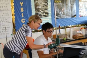 Submitted Physics teacher Pauline Cheeseman and Tom Liang, an international student from China, adjust a Vernier Motion Detector and ramp to collect data on velocity versus time.
