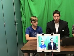Submitted WFMJ TV-21 news anchor Derek Steyer, right, anchors the daily announcements with eighth-grader Samuel L. Steyer visited the class Oct. 7 to discuss the communications field.