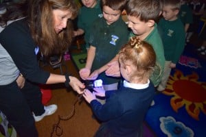 Submitted Nurse Paula Leonette shines a blue light on students’ hands to show the germs that may have been left behind if they do not wash their hands properly.