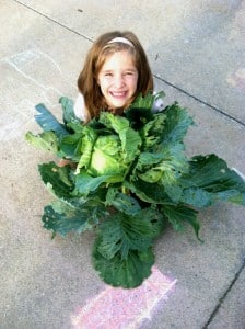 Submitted CIS student Haylie R. takes a photo with the cabbage she grew through the Bonne Plants 3rd Grade Cabbage Program.
