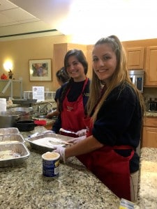 Submitted Juniors Madison Mitchell, left, and Olivia Farone prepare lunch for the residents of Ronald McDonald House in University Circle during their retreat on Oct. 27.