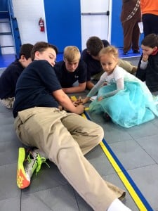 Submitted Quentin Fedak, Ethan McCaskey and Katya Cobb build a mini catapult during the Halloween carnival.