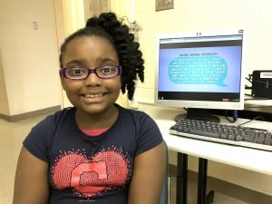 Submitted Fourth-grader Sakena W. sits in front of her opinion about solar cars that was broadcast and read during the Oct.13 WVIZ/PBS Ideastream program NewsDepth.