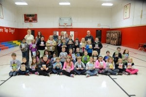 Submitted Cardinal Intermediate School third-graders display the books they received from the East Geauga Kiwanis Club. With the students are Melissa Cardinal, Camille Becker, Ken and Linda Humphrey and Mike Topalian in the back row.